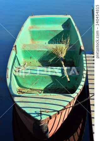 Old rowboat tied to dock Old rowboat tied to dock 140454815