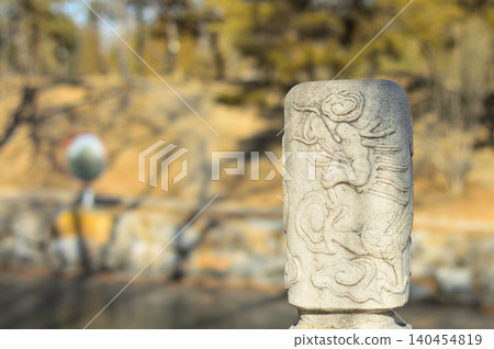 Carved stone post in a peaceful park Carved stone post in a peaceful park 140454819