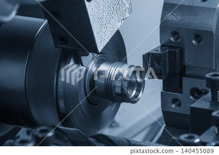 Advanced multi-tasking CNC lathe machine executing high-precision cutting on a complex metal part. Advanced multi-tasking CNC lathe machine executing high-precision cutting on a complex metal part. 140455089
