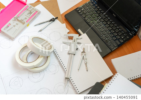 Study Workspace Laptop, Technical Drawings, Vernier Caliper, Compasses and Stationery Tools Study Workspace Laptop, Technical Drawings, Vernier Caliper, Compasses and Stationery Tools 140455091