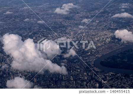 Bangkok city's bird eye view shot from a plane that flight in a morning with warming color of sunrise and some shade from clouds photo may had some noise and partly blur Bangkok city's bird eye view shot from a plane that flight in a morning with warming color of sunrise and some shade from clouds photo may had some noise and partly blur 140455415