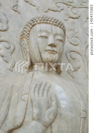 Stone Buddha statue with raised hand Stone Buddha statue with raised hand 140455865