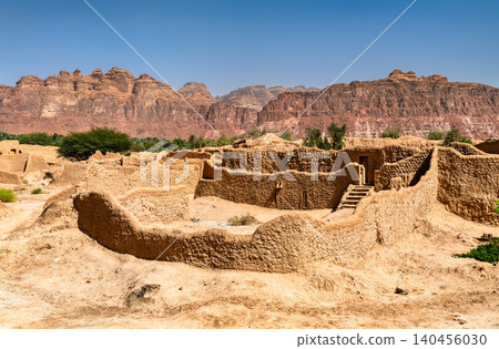 Detailed view of the ancient mud brick structures and traditional architecture of the AlUla Old Town ruins with rocky mountains in the background, Saudi Arabia. Detailed view of the ancient mud brick structures and traditional architecture of the AlUla Old Town ruins with rocky mountains in the background, Saudi Arabia. 140456030