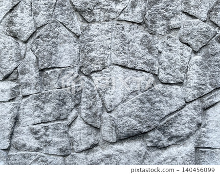 A gray stone wall texture background with beautiful natural stone patterns. A gray stone wall texture background with beautiful natural stone patterns. 140456099