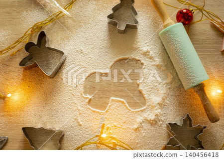 A horse-shaped gingerbread on a table with flour and a rolling pin. Baking Christmas cookies. Christmas background A horse-shaped gingerbread on a table with flour and a rolling pin. Baking Christmas cookies. Christmas background 140456418