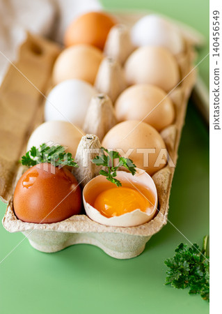 Organic chicken eggs with yolk and kitchen tools on table Organic chicken eggs with yolk and kitchen tools on table 140456549