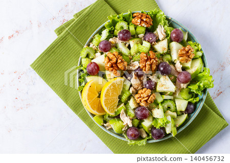 Fresh Waldorf salad, celery stalk with chicken, apple and walnuts, grapes, herbs, homemade, without people, Fresh Waldorf salad, celery stalk with chicken, apple and walnuts, grapes, herbs, homemade, without people, 140456732