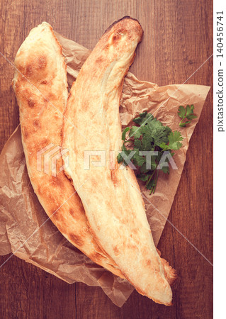 Georgian bread shotis, shotis puri, on a wooden table, top view, 140456741
