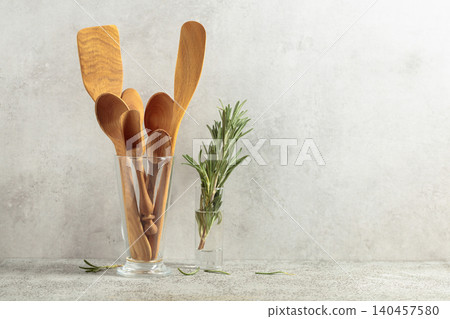 Wooden kitchen utensils and rosemary. Wooden kitchen utensils and rosemary. 140457580