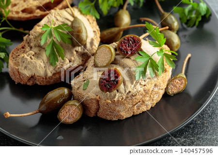 Bread with liver pate, capers, and fresh parsley. Bread with liver pate, capers, and fresh parsley. 140457596