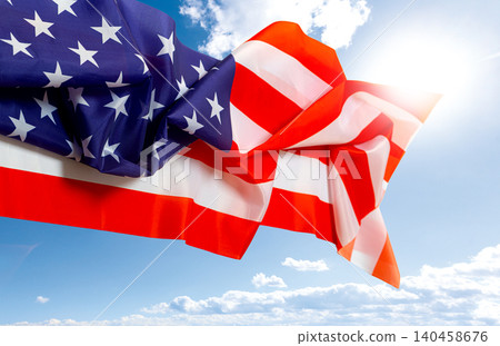 American flag waving in sunny blue sky American flag waving in sunny blue sky 140458676