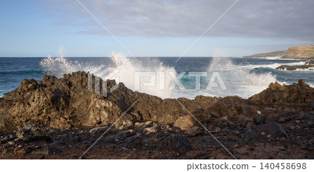 Ocean Waves Crashing on Volcanic Rocky Coast 140458698