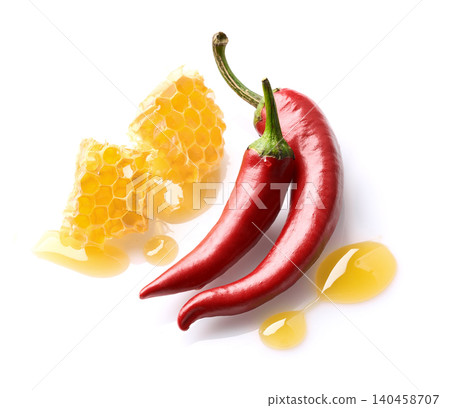 Honeycomb and hot red peppers on white background Honeycomb and hot red peppers on white background 140458707
