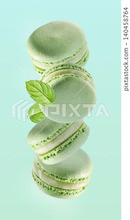 Mint macaroons with mint leaves on green background Mint macaroons with mint leaves on green background 140458764