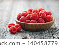 Raspberry closeup on wooden background 140458779