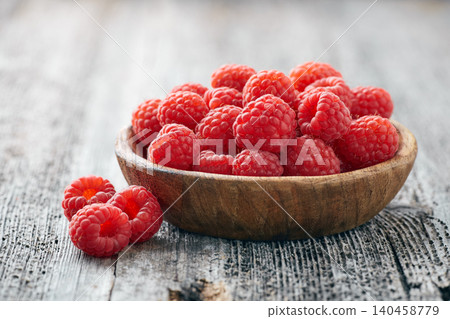 Raspberry closeup on wooden background Raspberry closeup on wooden background 140458779