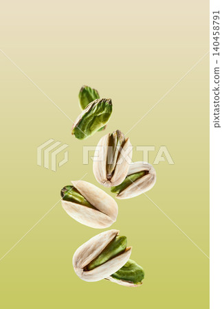 Flying pistachio nuts in closeup on pistachio background Flying pistachio nuts in closeup on pistachio background 140458791