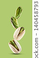Stack pistachio nuts in closeup on pistachio background 140458793
