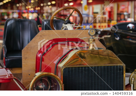 Vintage car front view showcasing hood, grille, headlights in museum setting Vintage car front view showcasing hood, grille, headlights in museum setting 140459316