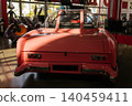 Pink futuristic car with bubble canopy and cartoon characters indoors 140459411