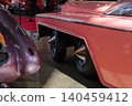 Two custom cars in exhibition space with unique wheel covers 140459412