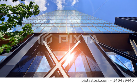 Eco building in modern city concept. Modern office building with the fresh green leaves. Steel and glass. The subject of modern architecture or construction industry. Eco building in modern city concept. Modern office building with the fresh green leaves. Steel and glass. The subject of modern architecture or construction industry. 140459440