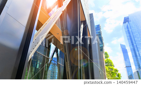Eco building in modern city concept. Modern office building with the fresh green leaves. Steel and glass. The subject of modern architecture or construction industry. Eco building in modern city concept. Modern office building with the fresh green leaves. Steel and glass. The subject of modern architecture or construction industry. 140459447