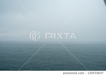 Heavy rain falls over the Bosphorus Strait as waves surge, creating a moody atmosphere and obscuring the horizon in a stormy afternoon setting. Heavy rain falls over the Bosphorus Strait as waves surge, creating a moody atmosphere and obscuring the horizon in a stormy afternoon setting. 140459647
