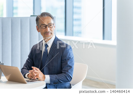 Senior businessman working with a personal computer Senior businessman working with a personal computer 140460414