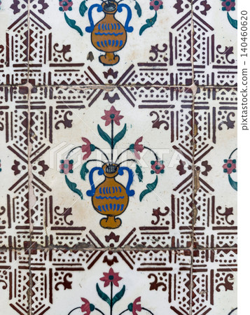 Close-up of vintage Portuguese azulejo tiles showing intricate hand-painted floral urn motifs surrounded by detailed geometric patterns in classic colors Close-up of vintage Portuguese azulejo tiles showing intricate hand-painted floral urn motifs surrounded by detailed geometric patterns in classic colors 140460620
