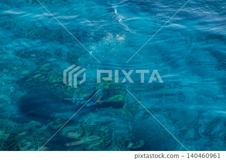 Turquoise water reveals vibrant coral reefs and fish swimming below, ideal for snorkelers exploring the underwater ecosystem on a bright day. Turquoise water reveals vibrant coral reefs and fish swimming below, ideal for snorkelers exploring the underwater ecosystem on a bright day. 140460961