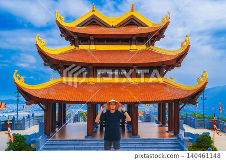 male tourist at Vietnamese Buddhist Golden Pagoda Truc Lam Phung Thuy Son in Nha Trang in Vietnam. Travel and culture in Vietnam in Asia 140461148