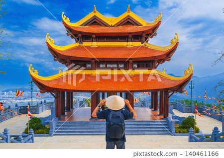 back of male tourist at Vietnamese Buddhist Golden Pagoda Truc Lam Phung Thuy Son in Nha Trang in Vietnam. Travel and culture in Vietnam in Asia 140461166