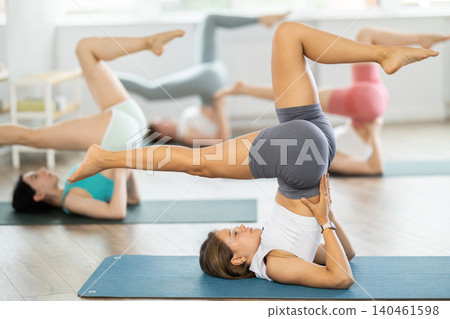 Group of young women doing yoga in studio Group of young women doing yoga in studio 140461598