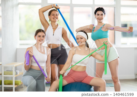 Group of young women posing with pilates equipment Group of young women posing with pilates equipment 140461599