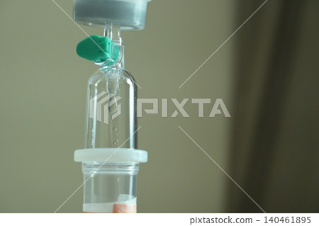 saline solution drip for patient and infusion pump in hospital, close up equipment of medicine 140461895