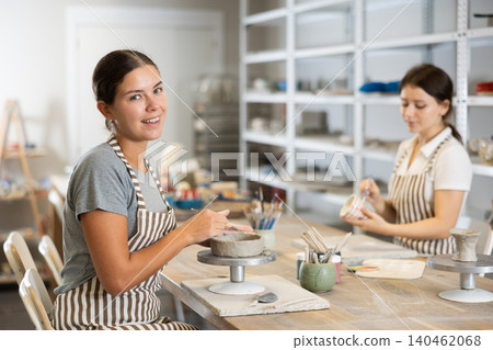Two young women sculpt and paint ceramics Two young women sculpt and paint ceramics 140462068