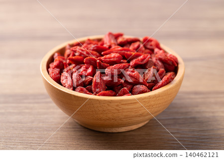 Organic dried goji berries in a bowl on wooden background. Healthy food Organic dried goji berries in a bowl on wooden background. Healthy food 140462121