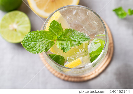 Refreshing iced lemon lime soda in a glass decorated with fresh mint leaves 140462144