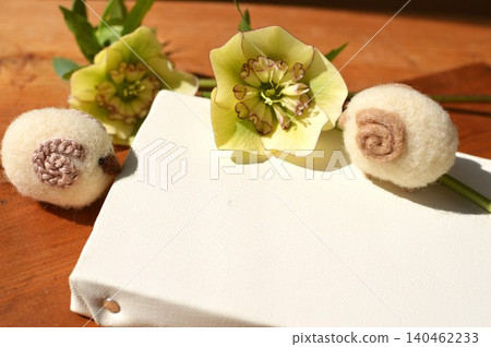 New Year's greeting card material featuring felt sheep and Christmas roses. 140462233