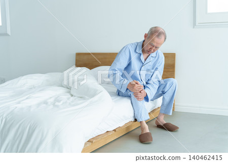 An elderly man suffering from knee pain An elderly man suffering from knee pain 140462415