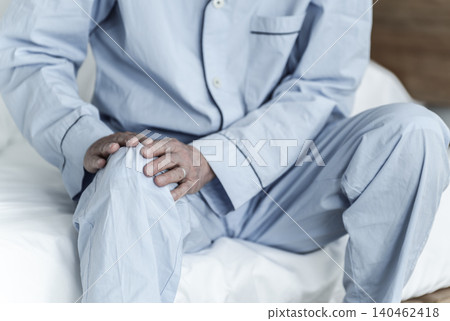 An elderly man suffering from knee pain An elderly man suffering from knee pain 140462418