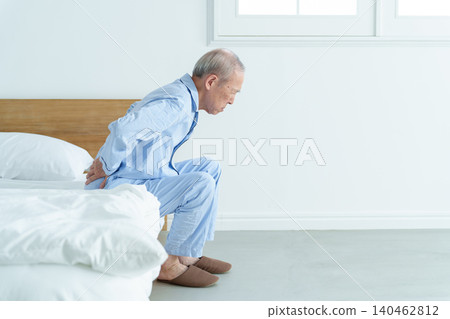 Elderly men suffering from low back pain Elderly men suffering from low back pain 140462812