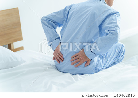 Elderly men suffering from low back pain Elderly men suffering from low back pain 140462819