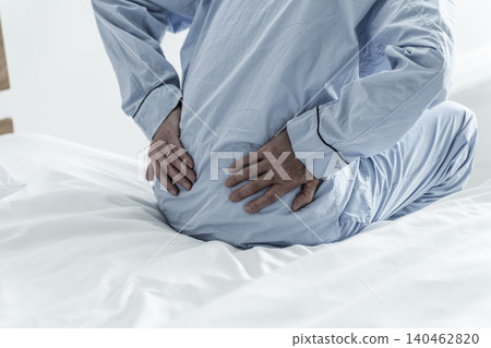 Elderly men suffering from low back pain 140462820