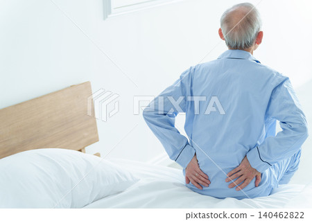 Elderly men suffering from low back pain Elderly men suffering from low back pain 140462822