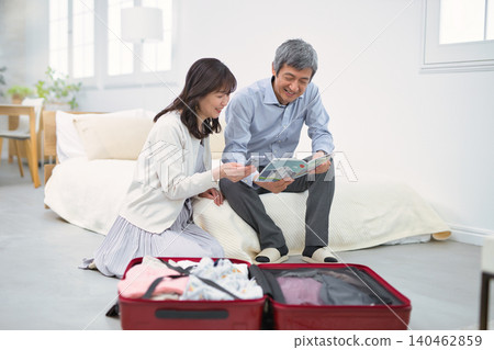 A smiling senior couple preparing for a trip. A smiling senior couple preparing for a trip. 140462859