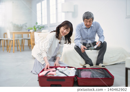 A smiling senior couple preparing for a trip. A smiling senior couple preparing for a trip. 140462902