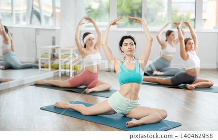 Group of young women doing yoga in studio Group of young women doing yoga in studio 140462938
