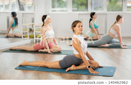 Group of young women doing yoga in studio 140462962